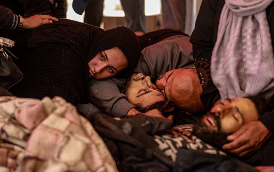 Relatives and loved ones mourn as they cling to the bodies of family members at the Indonesian Hospital in Gaza City. They were killed along with more than 100 other Palestinians in Israeli attacks on northern Gaza.
