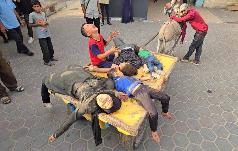 An Israeli attack on civilians gathered outside a health center in Deir al-Balah kills and injures numerous Palestinians, most of them women and children.